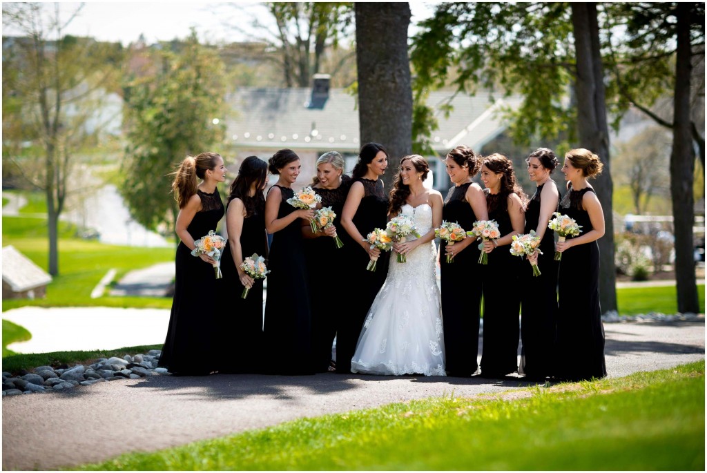 bridesmaids with the bride in black dresses with flowers at La Massaria at Bella Vista