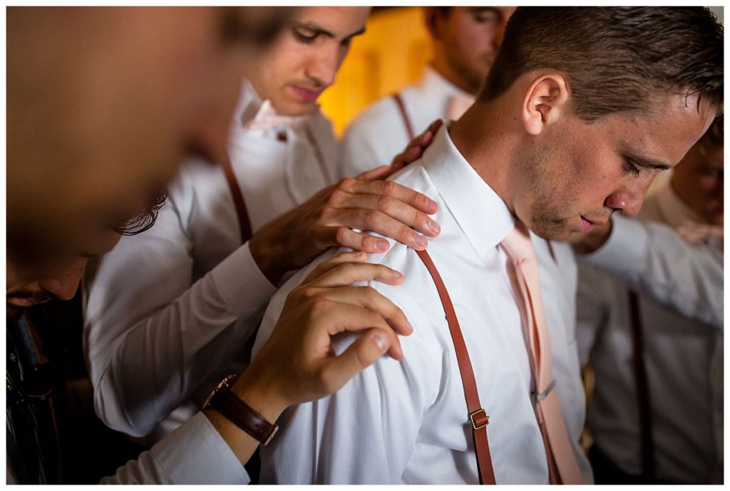 groomsmen praying over groom at the Publick House