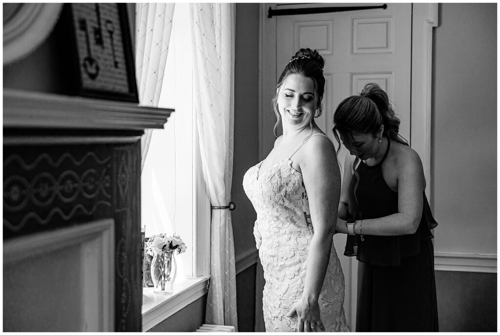 Bride getting ready on her wedding day with rings and flowers in golf course bridal suite