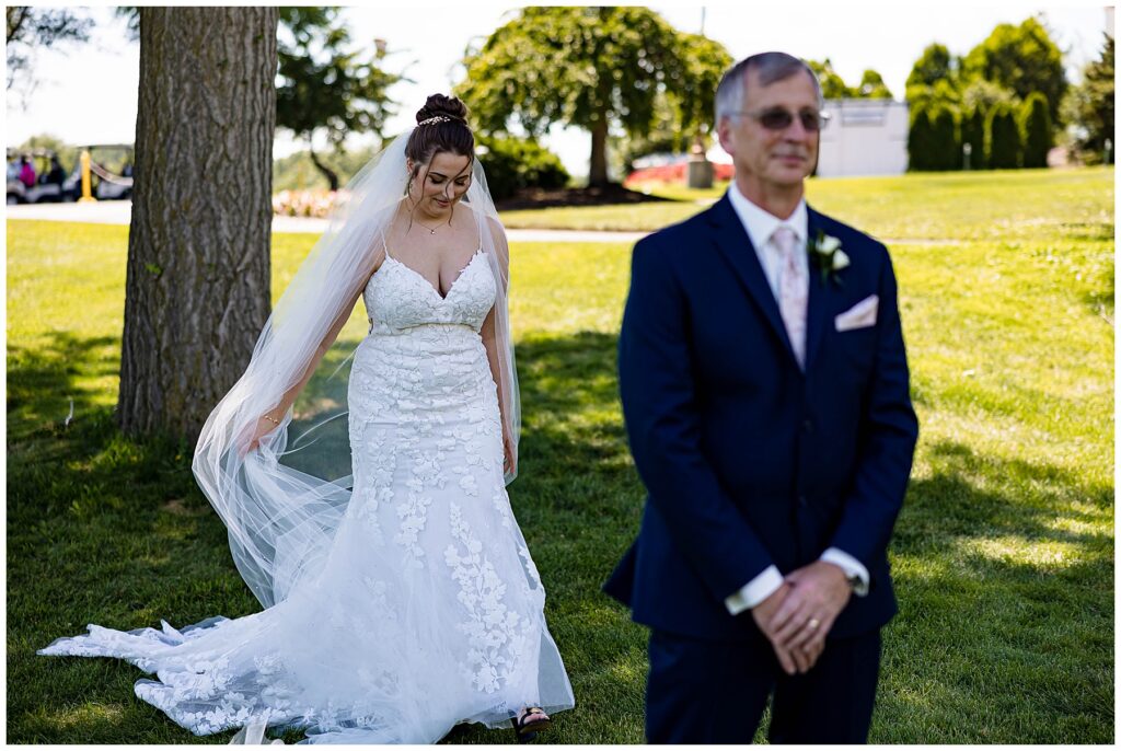 Wedding couple performing a first look on their wedding day in June on a golf course
