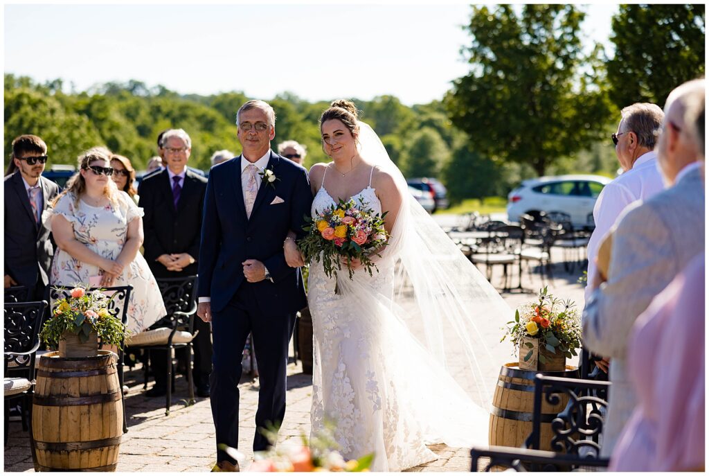 Wedding couple ties the knot under the sun on stone patio in Gilbertsville