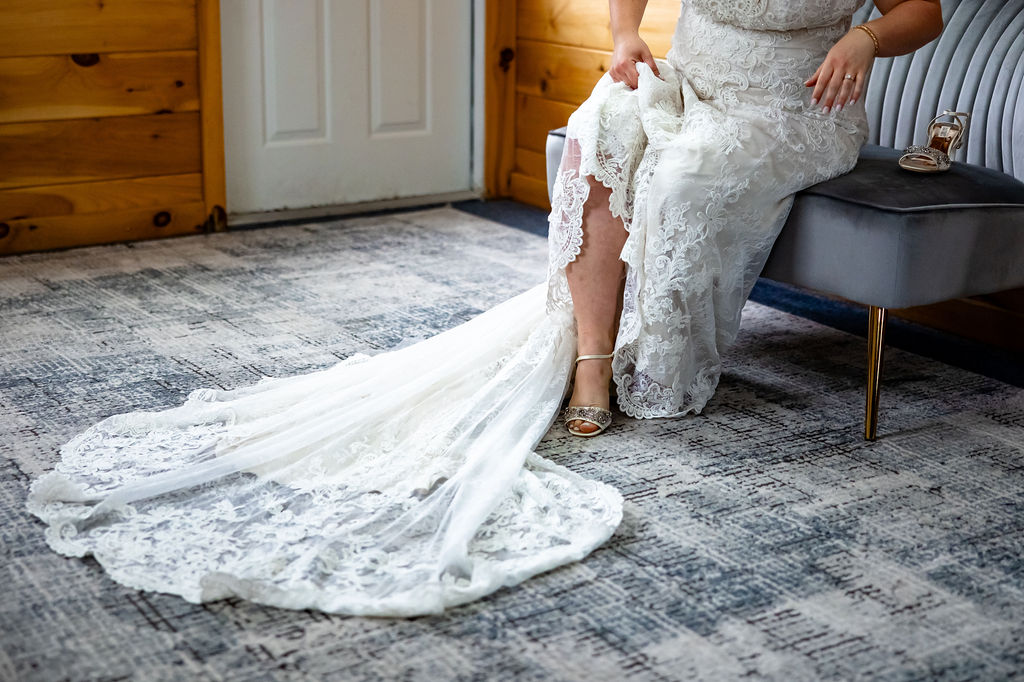 A bride puts on her heels. 