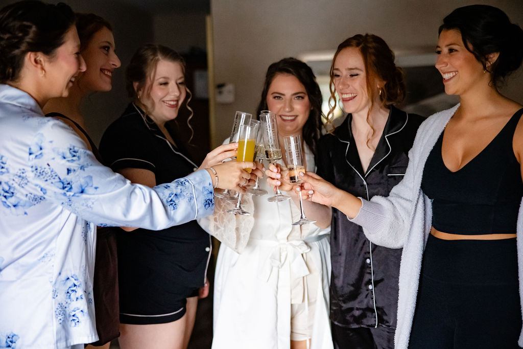 A bride toasts with her bridesmaids. 