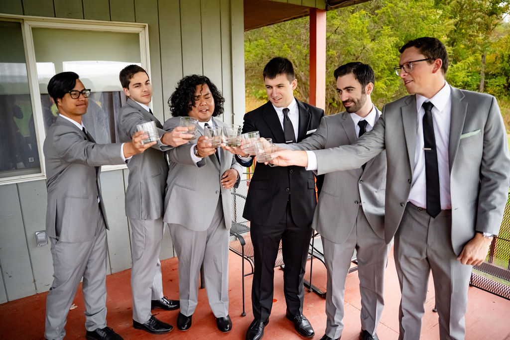 A groom toasts with his groomsmen. 