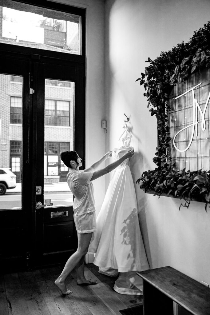 A bride admires her wedding dress. 