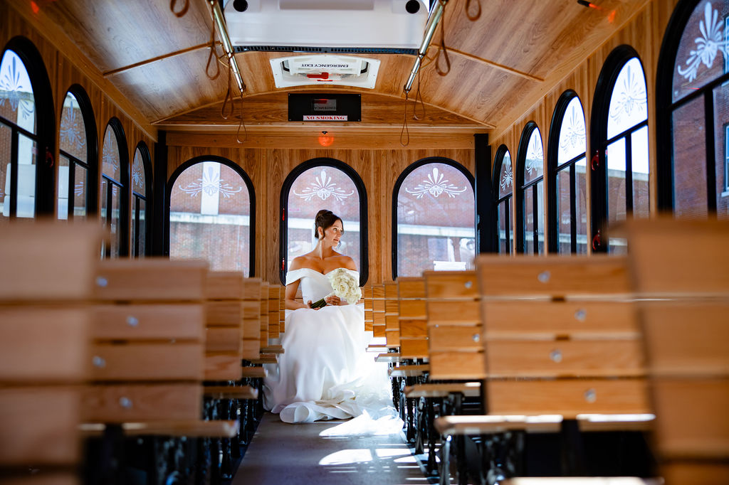 A bride rides in a trolley. 