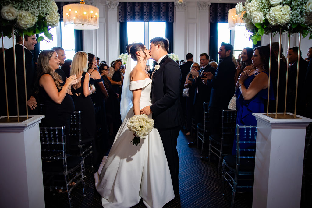 A bride and groom kiss at the downtown club philadelphia. 
